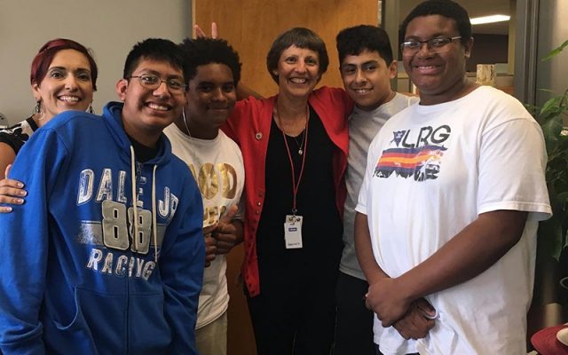 Photo of teacher with diverse students.
